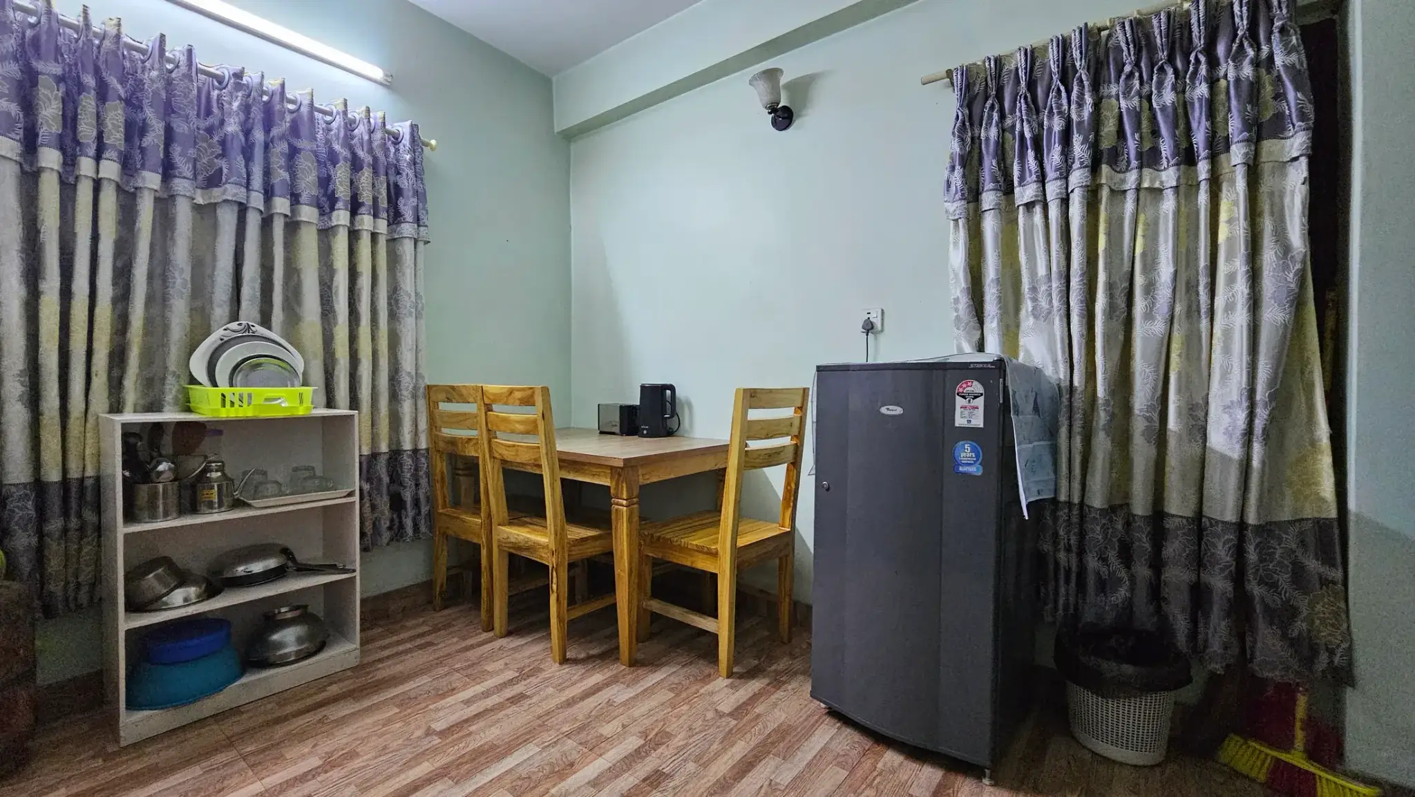 Apartment 3 dining area with refrigerator